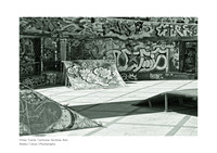 Artistic black-and-white photography that highlights the contrasts of street art in the urban landscape of Carbonia, Sardinia.