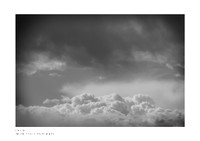 Fine art black-and-white print of clouds with dark frame effect, reminiscent of an airplane window view, design photography.