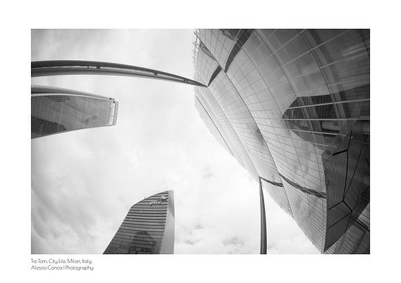Fine art black-and-white print of the Isozaki Tower, Hadid Tower, and Libeskind Tower in Milan’s CityLife district. Architectural photography taken with a fisheye lens that distorts the exterior metal