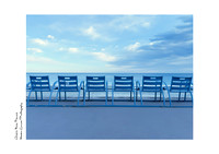 Fine Art Print of the iconic blue chairs along the Nice seafront with blue skies and clouds, great for offices and modern decor.