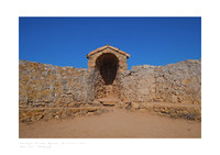 Fine art photograph of the walls of Fort Royal on Île Sainte-Marguerite, featuring sand-colored rocks and an deep blue sky.