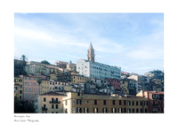A scene of Ventimiglia in December featuring colorful traditional Ligurian houses, a bright blue sky, and white clouds. Fine art photography for A5 fine art prints.